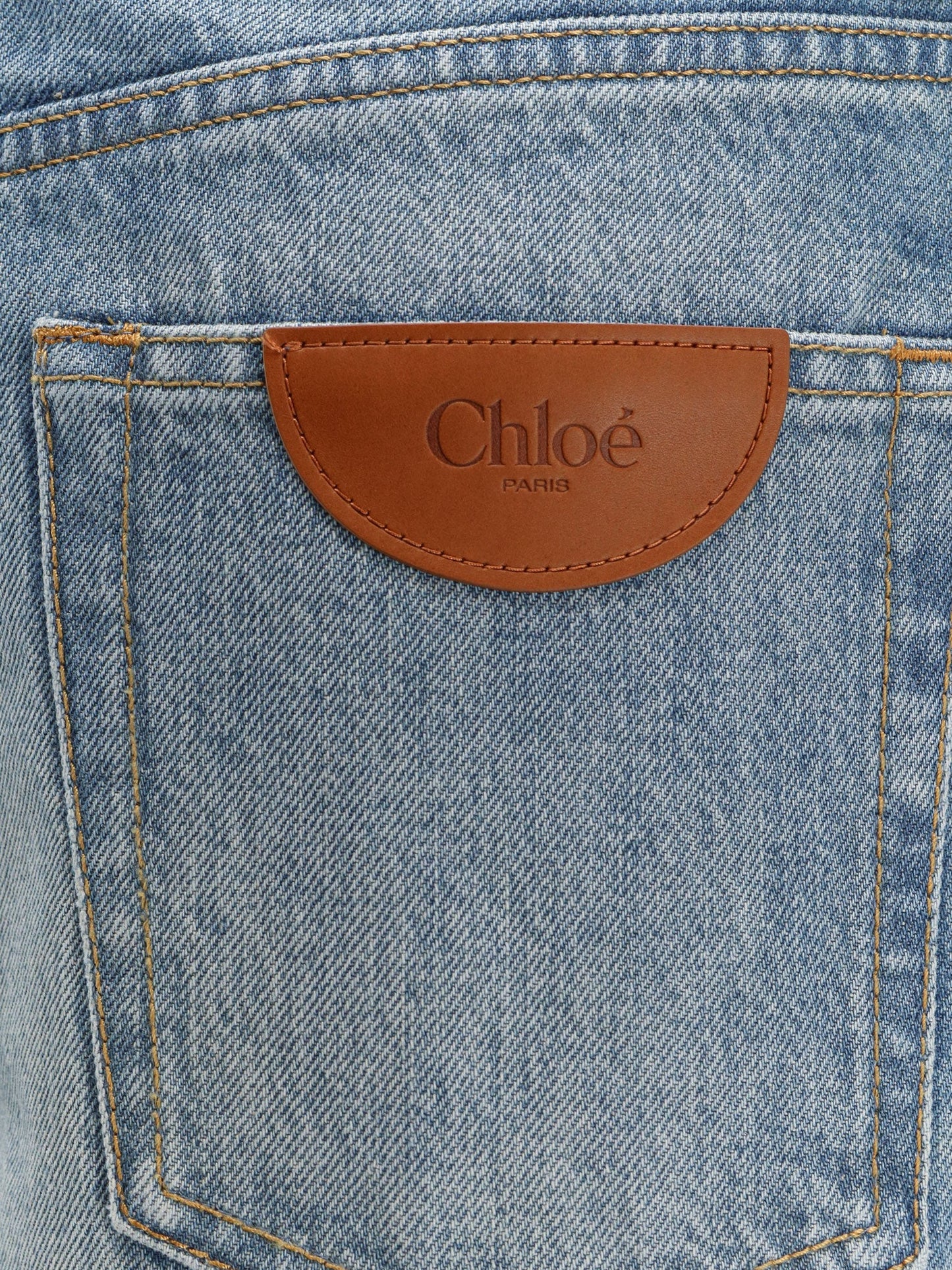 Blue denim jeans with logo label on the back