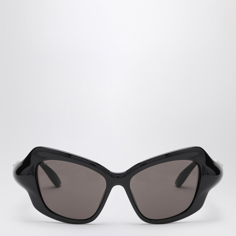 Black Balenciaga cat eye sunglasses with printed logo on the top left frame and black lenses.