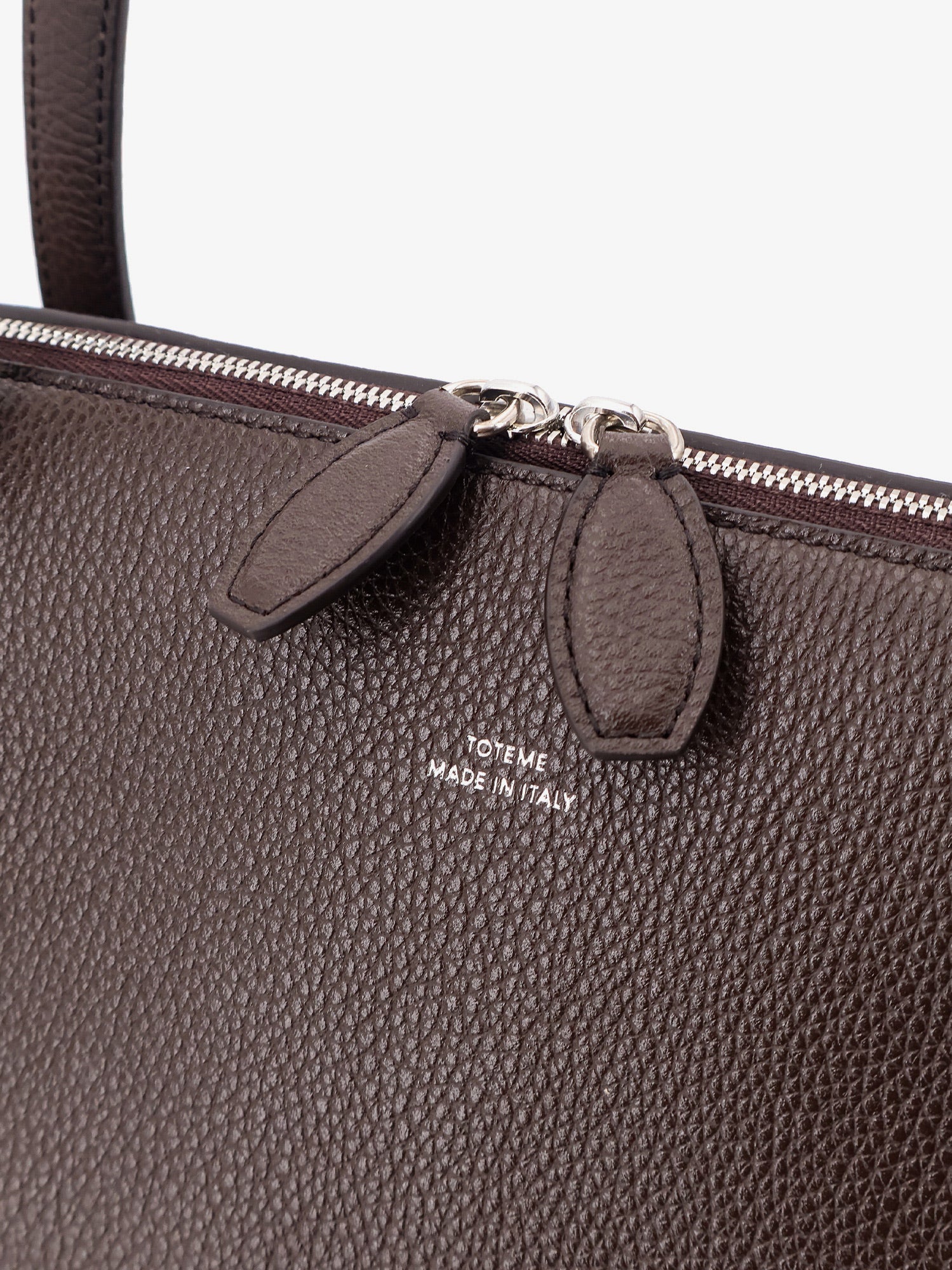 Suede handbag with engraved logo on the front