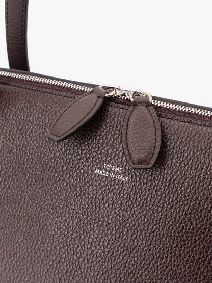 Suede handbag with engraved logo on the front