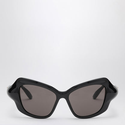 Black Balenciaga cat eye sunglasses with printed logo on the top left frame and black lenses.