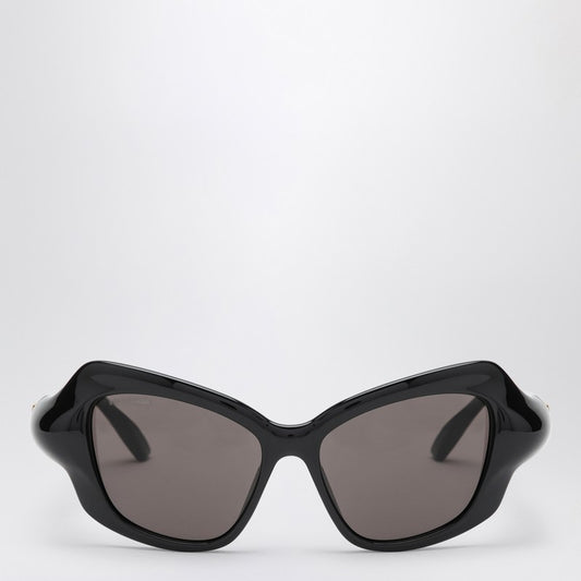 Black Balenciaga cat eye sunglasses with printed logo on the top left frame and black lenses.